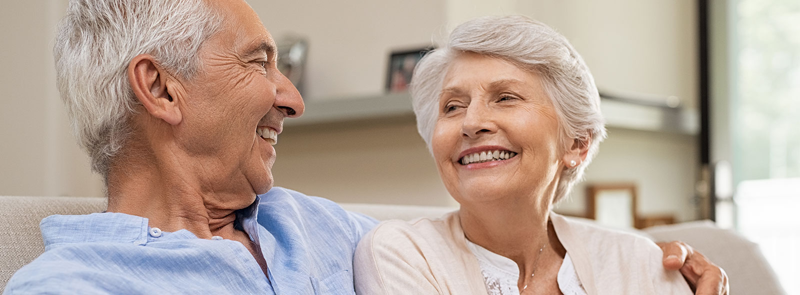Elderly married couple smiling and discussing the best skilled nursing facilities.