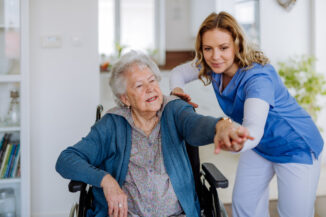 Skilled Nursing Employee Helping Senior Resident