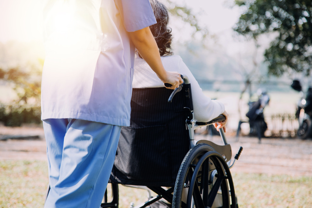 Skilled Nursing Employee Pushing a Wheelchair